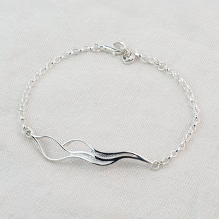 Tideline Bracelet in sterling silver, showing textured and polished curves, by Alison Moore Designs