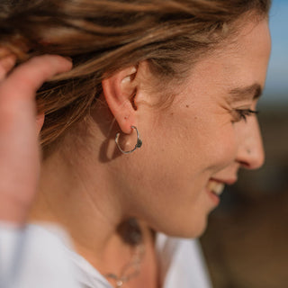 Woman with braided hair against a blurred natural background