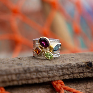 A stack of four Storybook rings in sterling silver and 9ct gold featuring warm-toned gemstones including Madeira Citrine in oval, square, oval and marquise cuts, by Alison Moore Designs