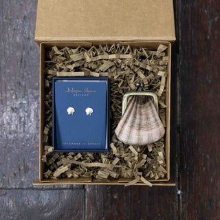 Jewelry set with earrings and a pendant in a box on a wooden surface
